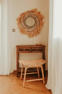 a table with a stool and a mirror on the wall at Maya pool & mountain view villa in Koskinou
