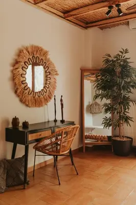 a room with a table and a mirror and a chair at Maya pool & mountain view villa in Koskinou