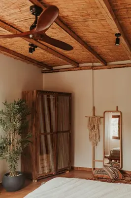 a bedroom with a ceiling fan and a mirror at Maya pool & mountain view villa in Koskinou