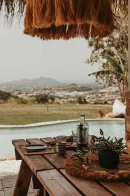 a wooden table with a drink on top at Maya pool & mountain view villa in Koskinou