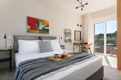 a bedroom with a large bed with a tray of fruit on it at Emmelia Villa in Ialyssos