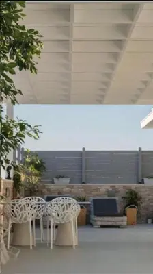two white chairs and a table in a building at Rhodes Center Luxurious Penthouse in Rhodes Town