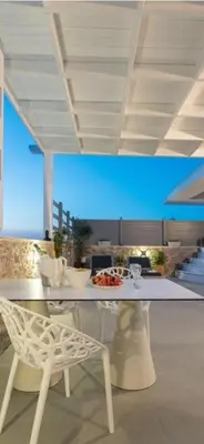 a table and a chair in a living room at Rhodes Center Luxurious Penthouse in Rhodes Town