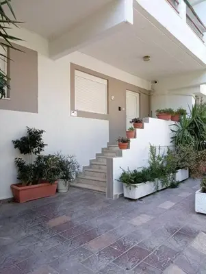 a house with stairs and potted plants on it at Katias downtown apartment in Rhodes Town