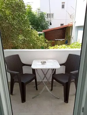 a small table and two chairs on a balcony at Katias downtown apartment in Rhodes Town