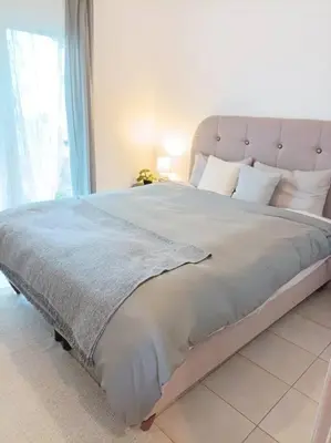 a large bed in a bedroom with a large window at Comfy Cozy Iksia in Ixia