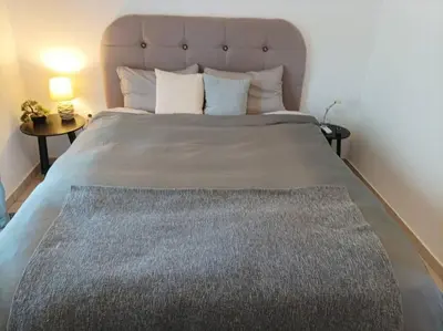 a bedroom with a large bed with a large headboard at Comfy Cozy Iksia in Ixia