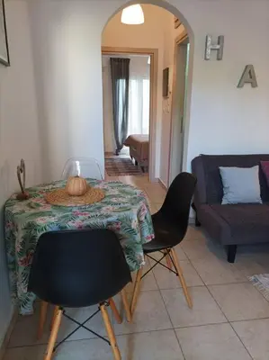 a living room with a table and chairs and a couch at Comfy Cozy Iksia in Ixia