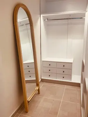 a dressing room with a mirror and a dresser at Naya pool & garden view bungalow in Koskinou