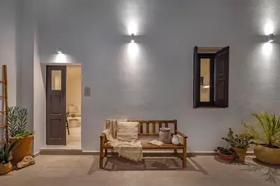 a room with a bench and a mirror on a wall at Noema Lindos - Angeliki Suite in Líndos