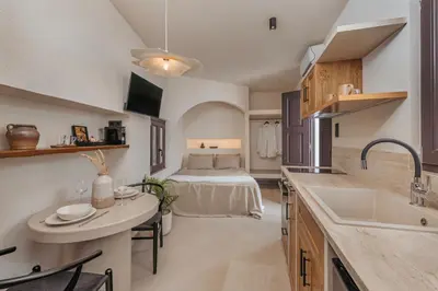 a kitchen with a sink and a bed in a room at Noema Lindos - Angeliki Suite in Líndos