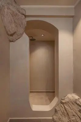 a hallway with a large rock on the wall at Noema Lindos - Angeliki Suite in Líndos