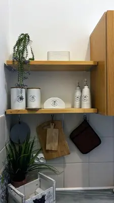 a shelf with three dishes and a plant on it at ANGELOS STUDIOS 3-4 in Faliraki Rhodes-Upper Floor in Faliraki
