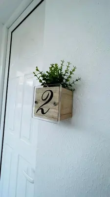 a plant in a wooden box on the side of a door at ANGELOS STUDIOS 3-4 in Faliraki Rhodes-Upper Floor in Faliraki