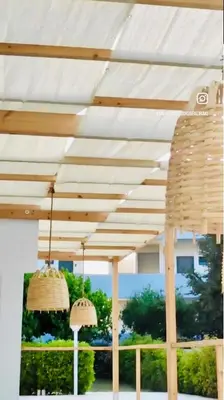 two baskets hanging under awning on a patio at ANGELOS STUDIOS 3-4 in Faliraki Rhodes-Upper Floor in Faliraki