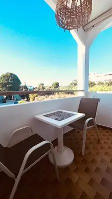 a white table and chairs in a room with a window at ANGELOS STUDIOS 3-4 in Faliraki Rhodes-Upper Floor in Faliraki