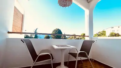 a balcony with a table and two chairs and a window at ANGELOS STUDIOS 3-4 in Faliraki Rhodes-Upper Floor in Faliraki