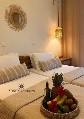 a hotel room with two beds with a tray of fruit at ANGELOS STUDIOS 3-4 in Faliraki Rhodes-Upper Floor in Faliraki