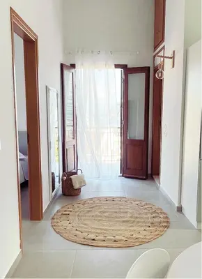 a living room with a large rug on the floor at Casa Chara 2 in Symi