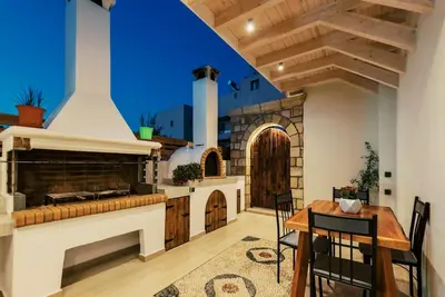 a large kitchen with a table and a stove at Myrovolos luxury Eneida's house in Ialyssos