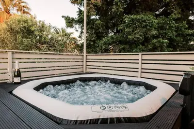 a hot tub sitting on top of a deck at Myrovolos luxury Angie's house in Ialyssos