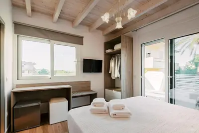 a bedroom with a bed with two towels on it at Myrovolos luxury Angie's house in Ialyssos