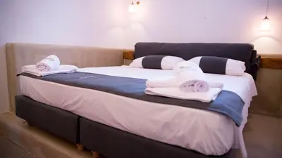 a bedroom with two beds with towels on them at Chic & Modern Apartments with swim access in Halki