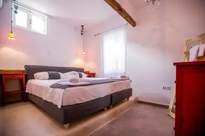 a bedroom with a bed in a room with a window at Chic & Modern Apartments with swim access in Halki