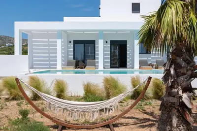 a hammock in front of a villa at Seastar Villa Large Pool & Jacuzzi Retreat in Lachania