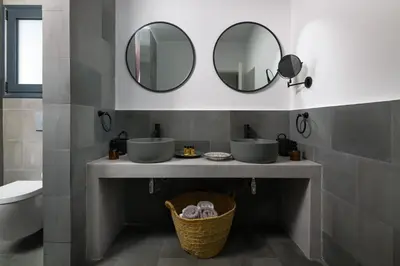 a bathroom with two sinks and two mirrors at Seastar Villa Large Pool & Jacuzzi Retreat in Lachania