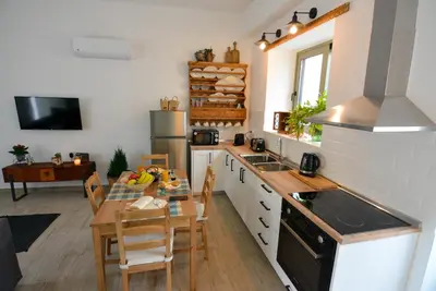 a kitchen with a table and a dining room at Anassa Mountain House in Émbonas