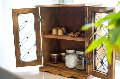 a wooden shelf with jars on it on a counter at Anassa Mountain House in Émbonas