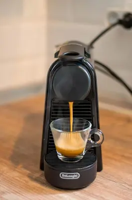 a coffee maker with a cup on a table at Anassa Mountain House in Émbonas