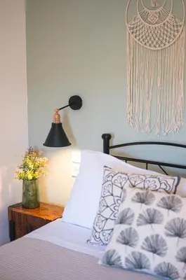 a bedroom with a bed and a table with a lamp at Anassa Mountain House in Émbonas