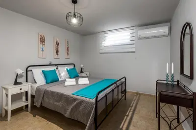 a bedroom with a bed with blue pillows at Mayas House Greece Rhodes Kremasti in Kremasti