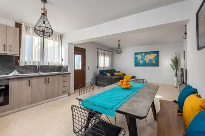 a kitchen and a living room with a table and chairs at Mayas House Greece Rhodes Kremasti in Kremasti