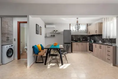 a kitchen with a table and chairs in a room at Mayas House Greece Rhodes Kremasti in Kremasti