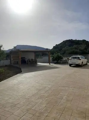 a car parked in a parking lot with a pavilion at Mayas House Greece Rhodes Kremasti in Kremasti