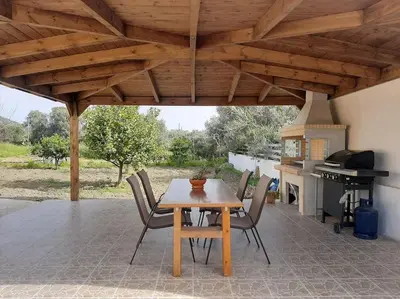 a patio with a table and chairs and a stove at Mayas House Greece Rhodes Kremasti in Kremasti