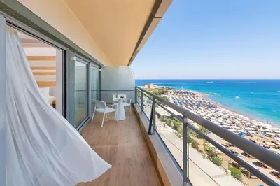 a balcony with a view of the beach at Mediterranean Hotel in Rhodes Town