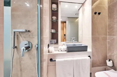 a bathroom with a sink and a shower at Mediterranean Hotel in Rhodes Town