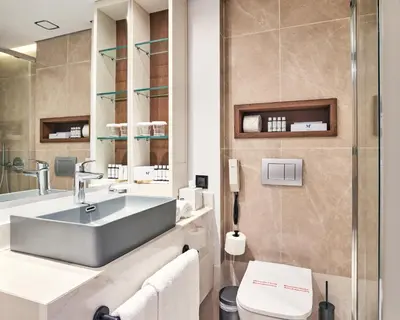 a bathroom with a sink and a toilet at Mediterranean Hotel in Rhodes Town