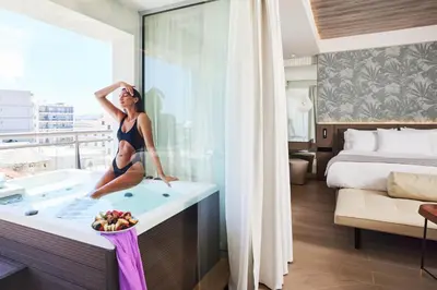 a woman sitting in a bath tub in a hotel room at Mediterranean Hotel in Rhodes Town
