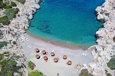 an aerial view of a beach with chairs and umbrellas at Laurel LK Houses in Kritinia Rhodes in Kritinía
