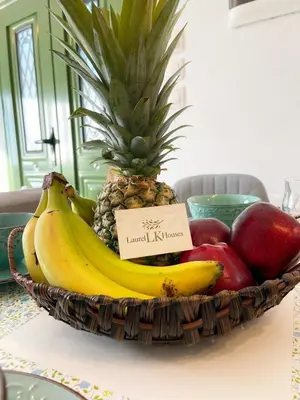 a basket of fruit with bananas apples and a pineapple at Laurel LK Houses in Kritinia Rhodes in Kritinía