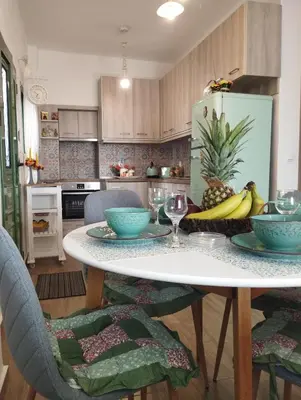 a kitchen with a table with a bowl of fruit on it at Laurel LK Houses in Kritinia Rhodes in Kritinía
