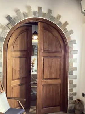 an archway with two wooden doors in a room at Casa Charma in Émbonas