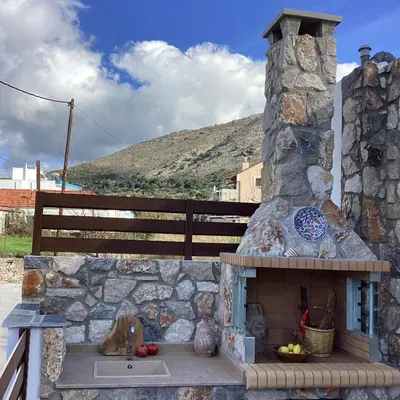 a stone outdoor oven with a stone wall at Casa Charma in Émbonas
