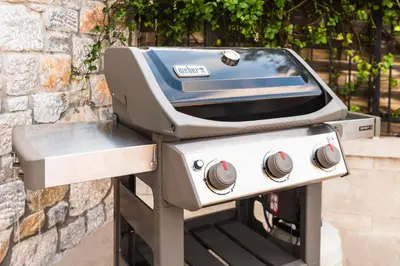 a gas grill in front of a brick wall at Ialyssos Charme Villa in Ialyssos