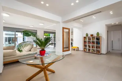 a living room with a glass table and a couch at Ialyssos Charme Villa in Ialyssos